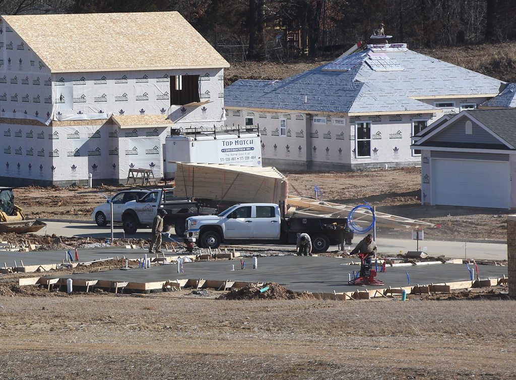 Construction workers lay cement